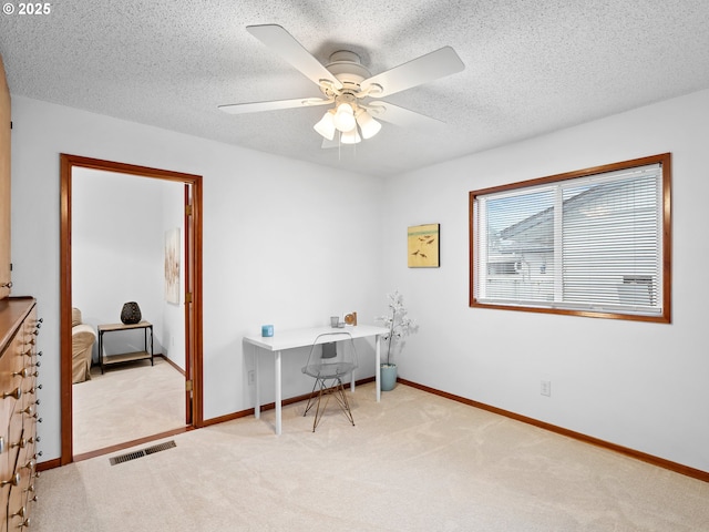 office with ceiling fan, light colored carpet, and a textured ceiling