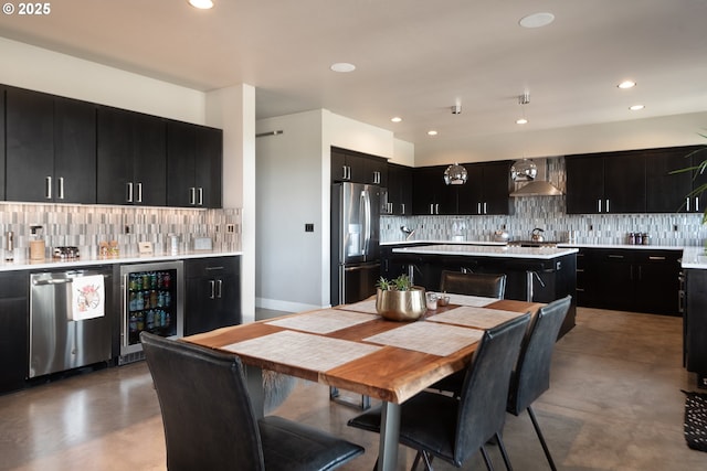 dining room with wine cooler, finished concrete floors, recessed lighting, and bar