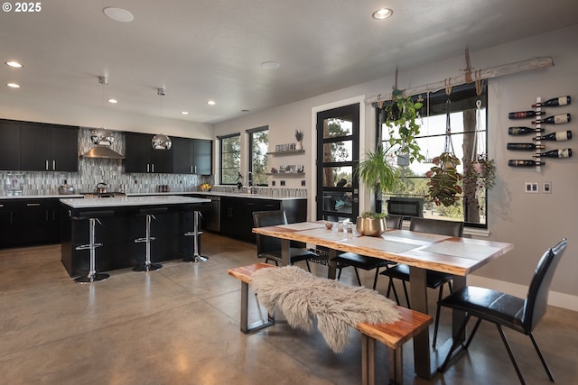dining area with concrete flooring and recessed lighting