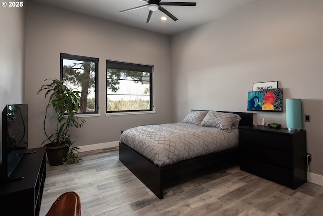 bedroom with light wood-style flooring, baseboards, recessed lighting, and a ceiling fan