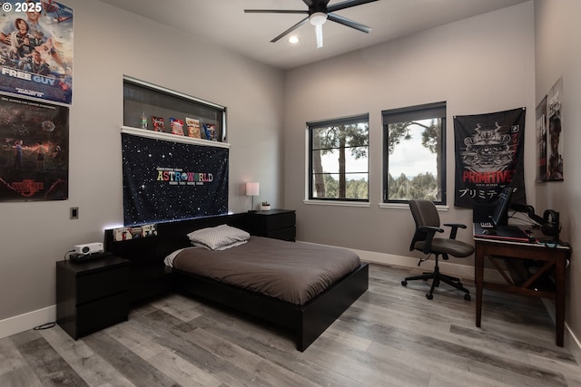bedroom featuring recessed lighting, wood finished floors, baseboards, an office area, and ceiling fan