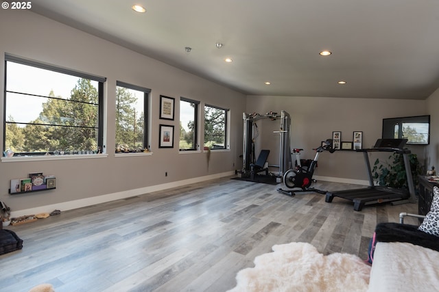 workout area with light wood-type flooring, recessed lighting, and baseboards