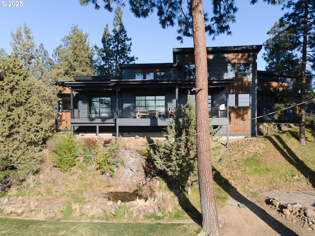 rear view of house featuring a balcony