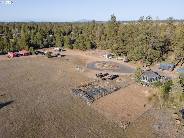 aerial overview of property's location with a heavily wooded area