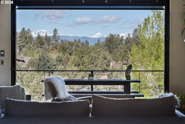balcony featuring a mountain view and a forest view