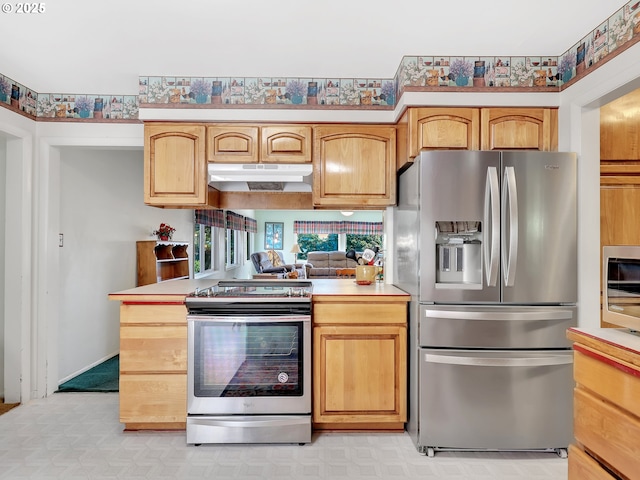 450 Pleasant Ave, Astoria, OR 97103 - kitchen with appliances with stainless steel finishes, under cabinet range hood, light countertops, and a peninsula