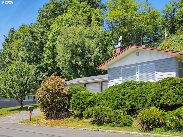450 Pleasant Ave, Astoria, OR 97103 - view of home's exterior with a chimney and a garage