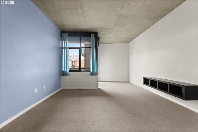 unfurnished room featuring carpet floors and baseboards