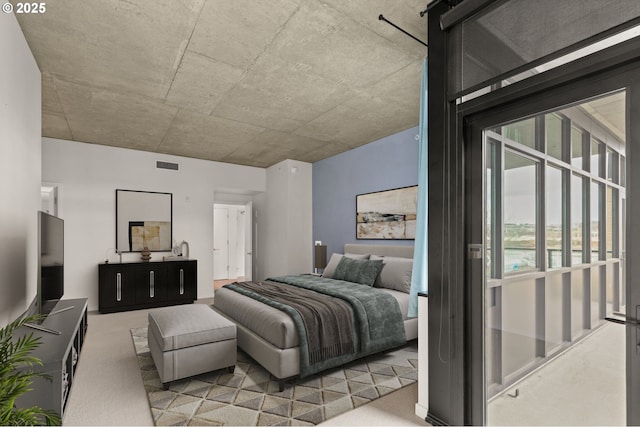 carpeted bedroom with visible vents and a barn door