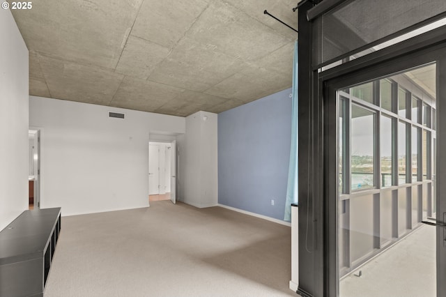 interior space with a barn door, visible vents, and baseboards