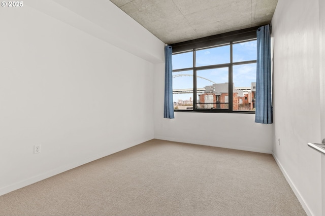 carpeted empty room with baseboards