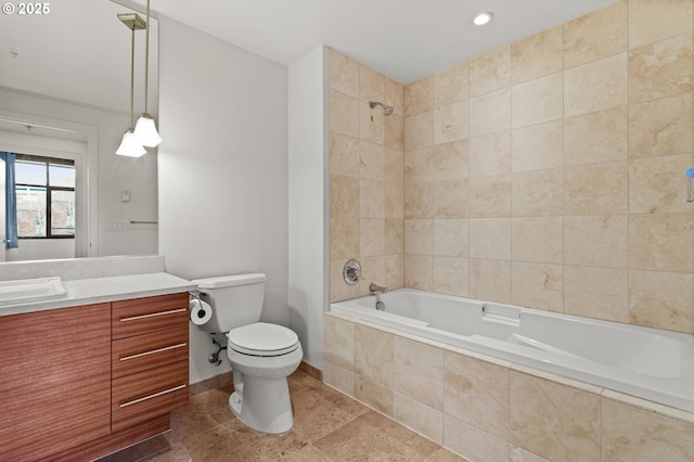 full bathroom featuring tiled shower / bath, toilet, vanity, and baseboards