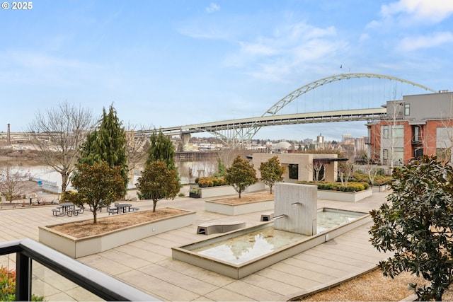 view of home's community with a water view and a city view