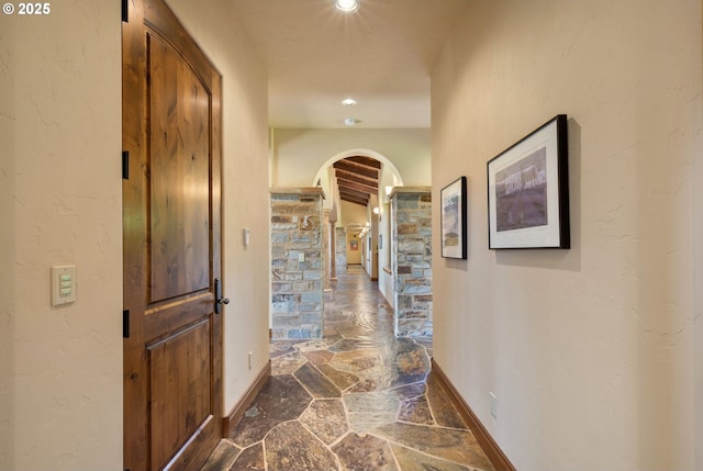 16465 Suntree Ln, Sisters, OR 97759 - hall featuring stone flooring, arched walkways, baseboards, and recessed lighting