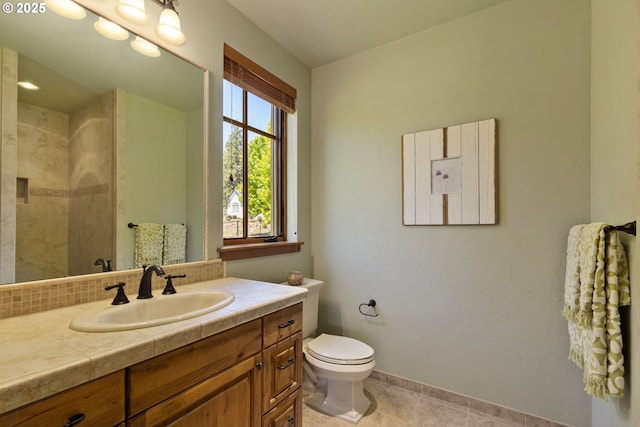 16465 Suntree Ln, Sisters, OR 97759 - bathroom featuring vanity, toilet, baseboards, tile patterned flooring, and a tile shower