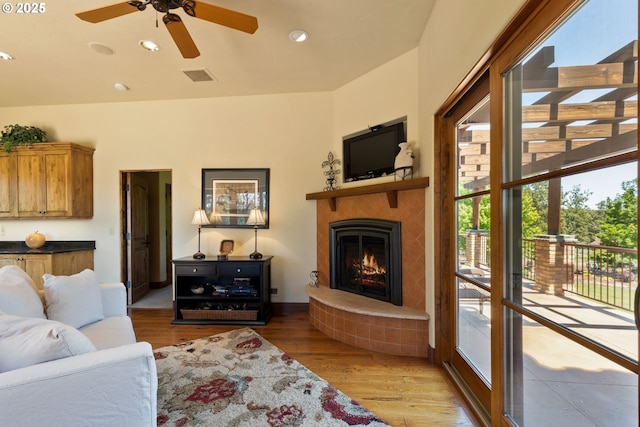 16465 Suntree Ln, Sisters, OR 97759 - living area featuring ceiling fan, wood finished floors, a lit fireplace, and recessed lighting