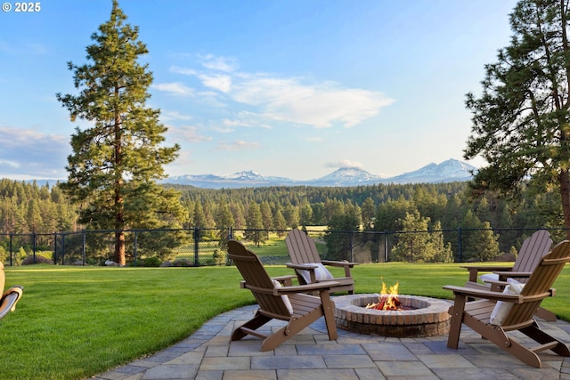 16465 Suntree Ln, Sisters, OR 97759 - view of patio with a wooded view, an outdoor fire pit, and a mountain view