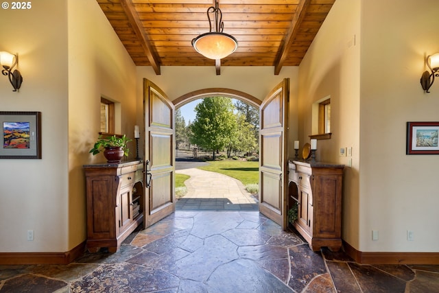 16465 Suntree Ln, Sisters, OR 97759 - foyer featuring stone tile floors, wooden ceiling with exposed beams, and baseboards