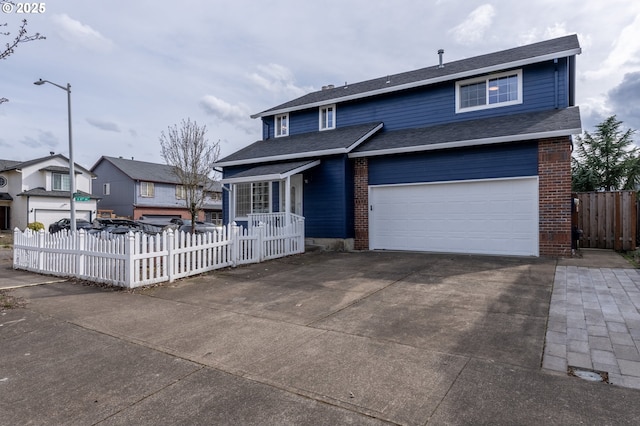 view of front of home featuring a shingled roof, concrete driveway, a garage, a fenced front yard, and brick siding