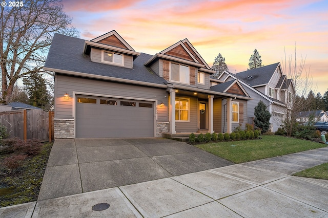 craftsman-style house with a garage and a lawn