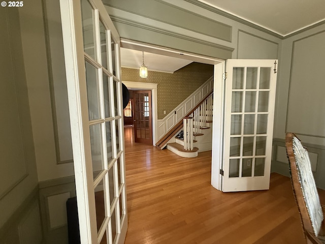 880 E 2nd St, Coquille, OR 97423 - entrance foyer featuring a decorative wall, french doors, light wood-type flooring, stairs, and wallpapered walls
