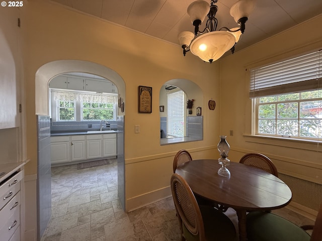 880 E 2nd St, Coquille, OR 97423 - dining room with stone tile floors, a chandelier, plenty of natural light, and arched walkways