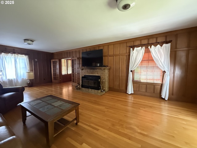 880 E 2nd St, Coquille, OR 97423 - living area with light wood-type flooring, a brick fireplace, and a decorative wall