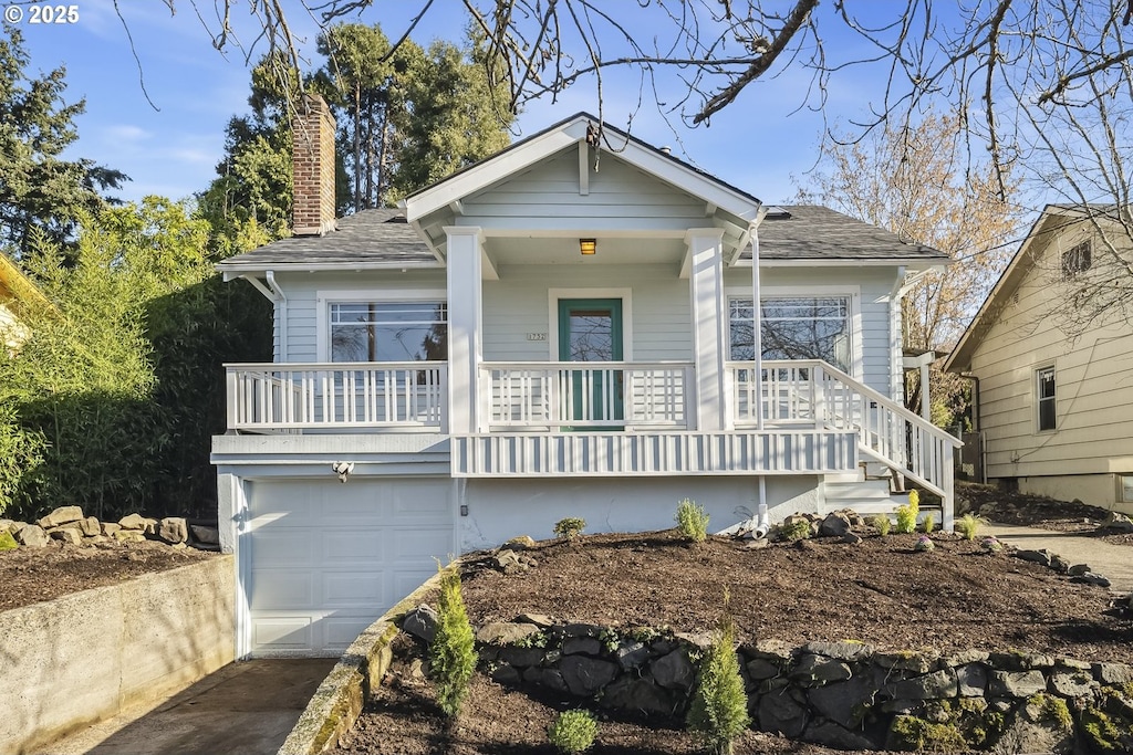 view of front of property with a garage and a porch