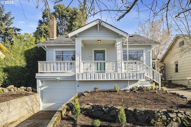 view of front of property with a garage and a porch