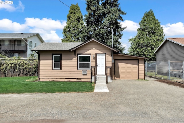view of front of property with a garage, fence, a front yard, roof with shingles, and driveway