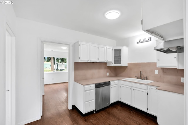 kitchen featuring stainless steel dishwasher, light countertops, white cabinetry, tasteful backsplash, and a sink