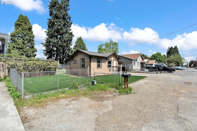 view of side of home with fence private yard and a lawn