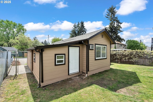 view of outbuilding featuring an outdoor structure, a gate, an AC wall unit, and a fenced backyard