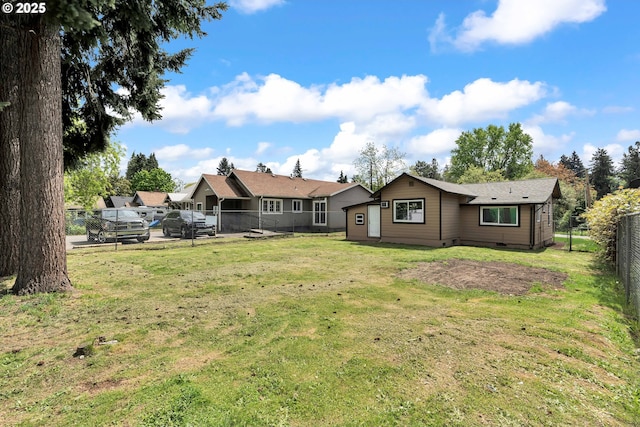 rear view of house with a fenced backyard, a yard, and crawl space