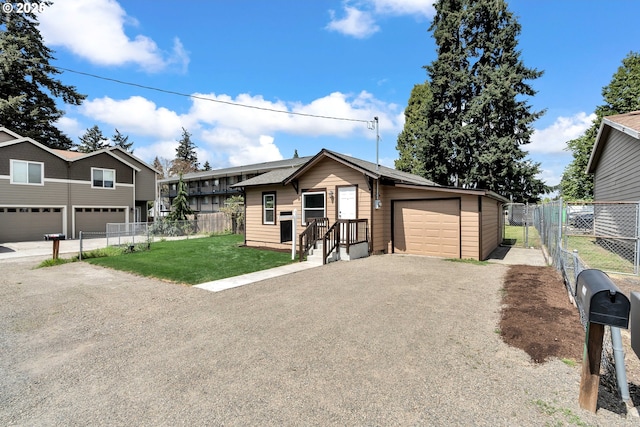 single story home with a front lawn, fence, and driveway