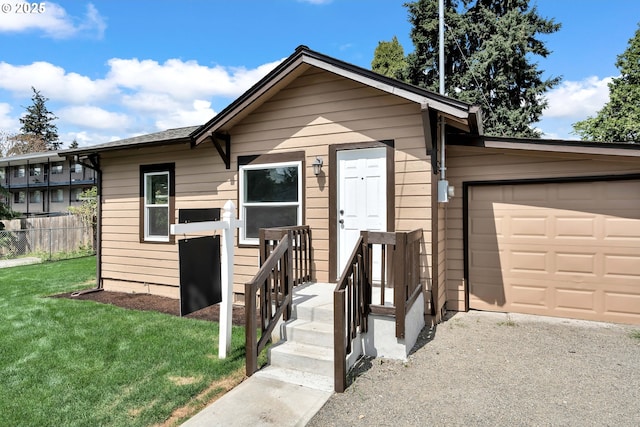 view of front facade featuring an attached garage, fence, and a front lawn