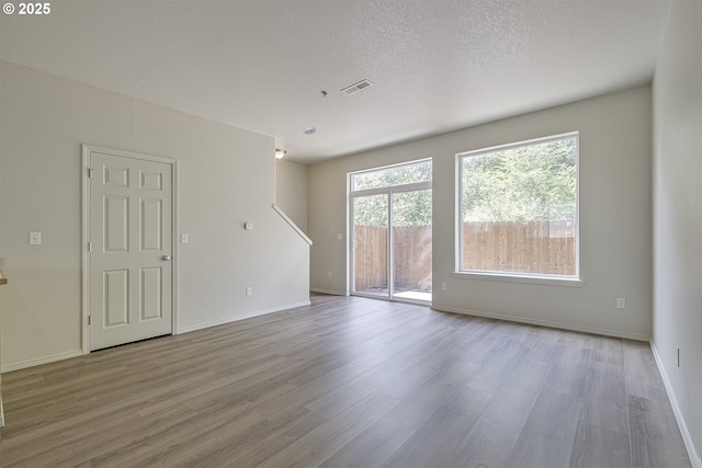 1115 NE 86th Way, Hillsboro, OR 97006 - unfurnished room featuring wood finished floors, baseboards, and a textured ceiling