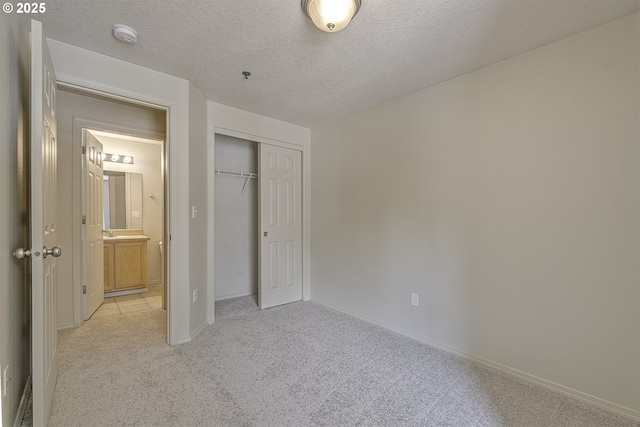1115 NE 86th Way, Hillsboro, OR 97006 - unfurnished bedroom featuring light carpet, a closet, baseboards, and a textured ceiling
