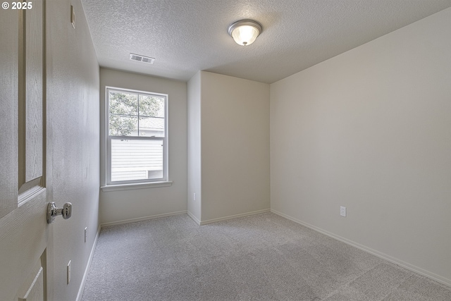 1115 NE 86th Way, Hillsboro, OR 97006 - spare room with a textured ceiling, carpet floors, and baseboards