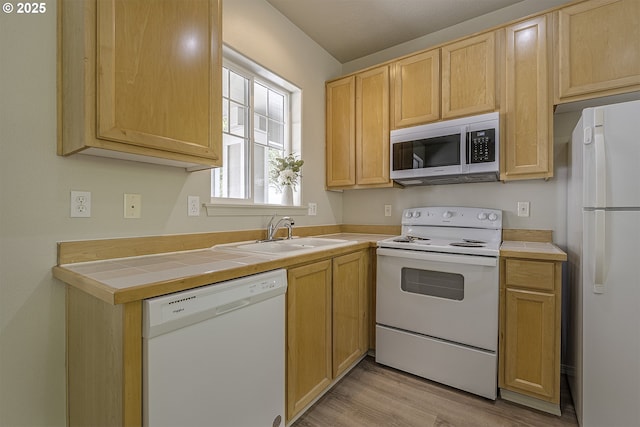 1115 NE 86th Way, Hillsboro, OR 97006 - kitchen featuring white appliances, a sink, light brown cabinets, light wood-type flooring, and tile counters
