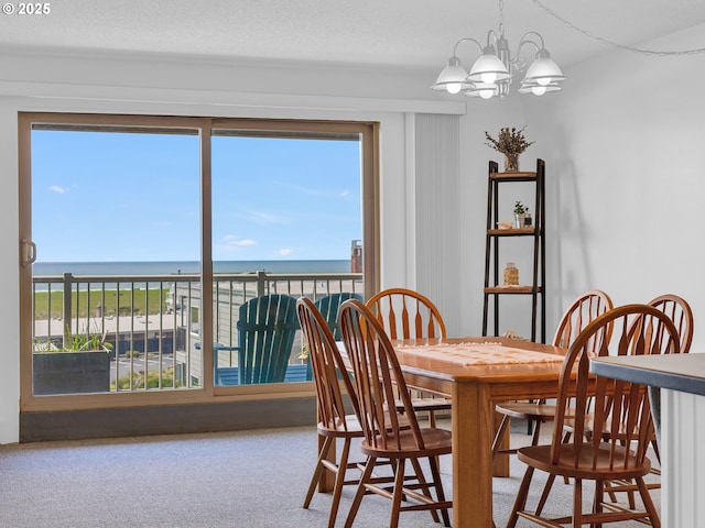 1146 N Marion Ave Unit 628, Gearhart, OR 97138 - dining area with a chandelier, a water view, and carpet flooring