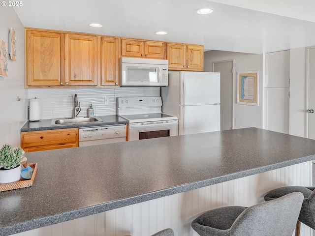 1146 N Marion Ave Unit 628, Gearhart, OR 97138 - kitchen with white appliances, a sink, dark countertops, a kitchen breakfast bar, and recessed lighting