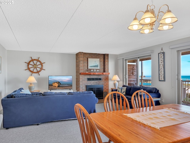 1146 N Marion Ave Unit 628, Gearhart, OR 97138 - dining room featuring a chandelier, carpet flooring, a textured ceiling, and a brick fireplace