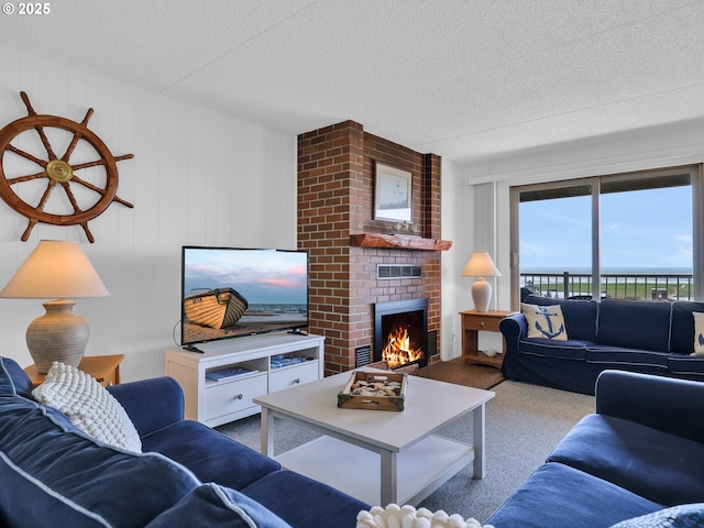 1146 N Marion Ave Unit 628, Gearhart, OR 97138 - carpeted living area featuring a textured ceiling and a fireplace