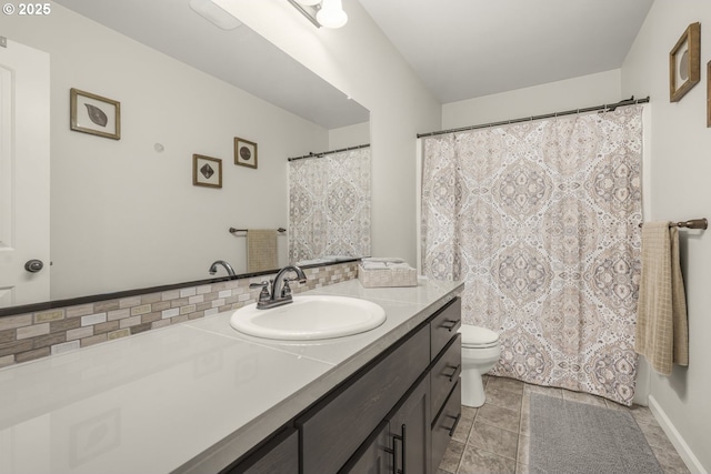 full bath featuring vanity, tasteful backsplash, and toilet