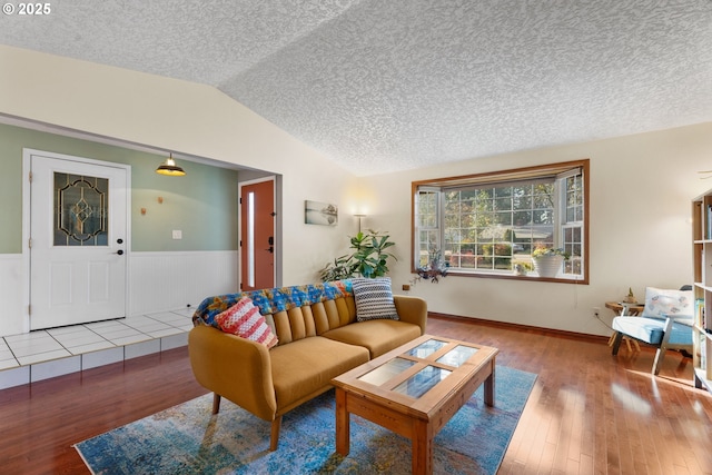 living room with hardwood / wood-style flooring and vaulted ceiling