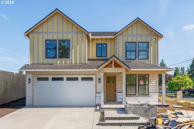 4410 NE 55th Way, Vancouver, WA 98661 - view of front facade with board and batten siding, concrete driveway, an attached garage, and a shingled roof