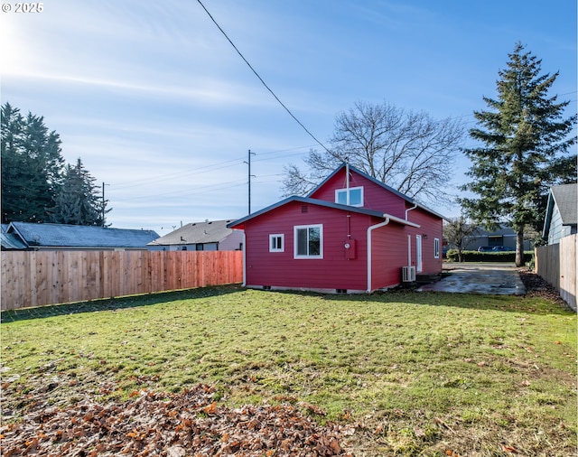 exterior space featuring central AC unit and a yard