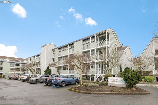 view of building exterior with uncovered parking