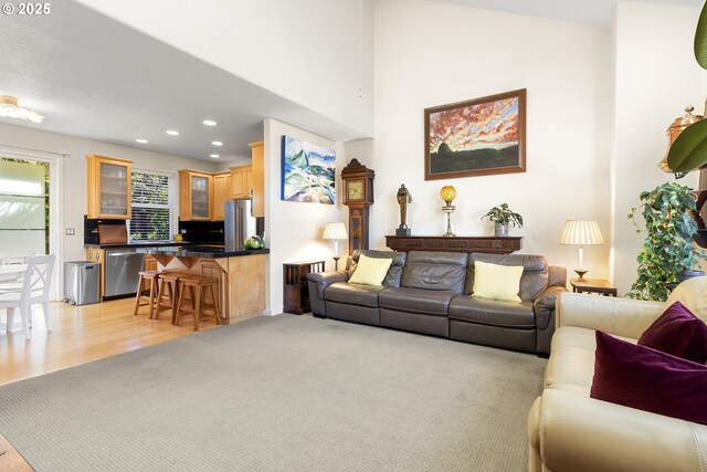 living room with lofted ceiling and light hardwood / wood-style floors